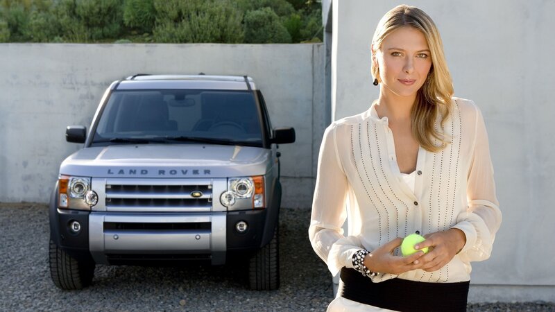 woman with tennis ball and land rover