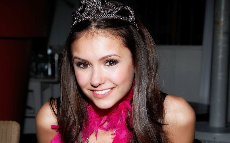 woman with tiara and pink feather boa