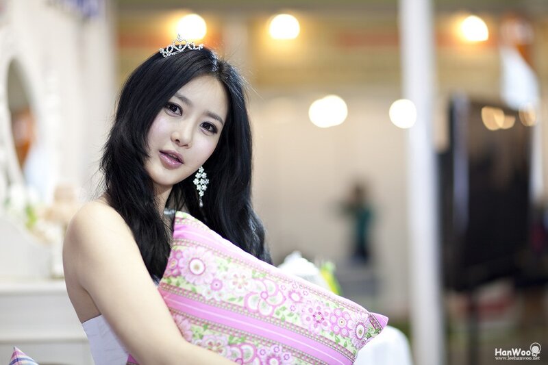 woman with tiara holding pillow