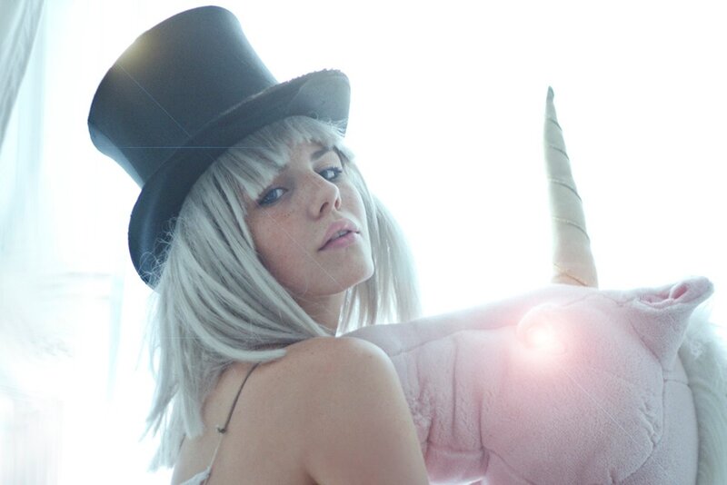 woman with top hat and unicorn