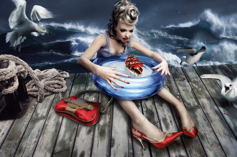 woman with toy ship on dock