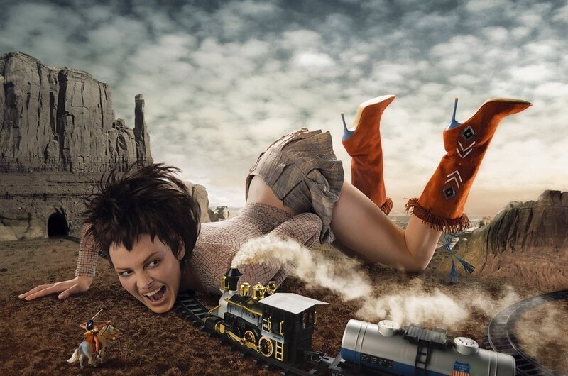 woman with toy train in desert