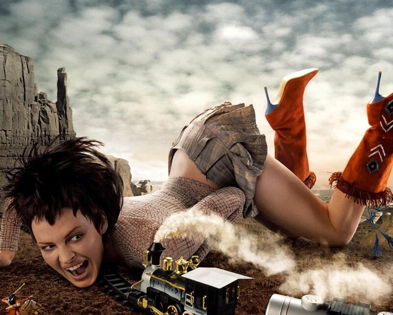 woman with toy train in desert