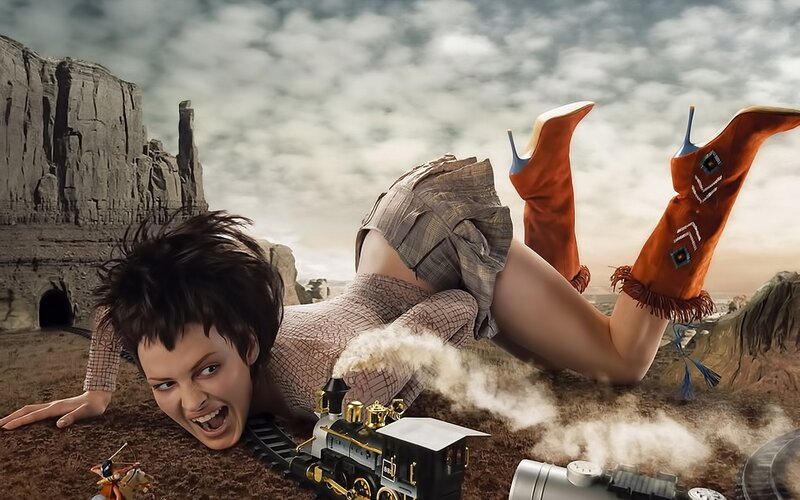 woman with toy train in desert