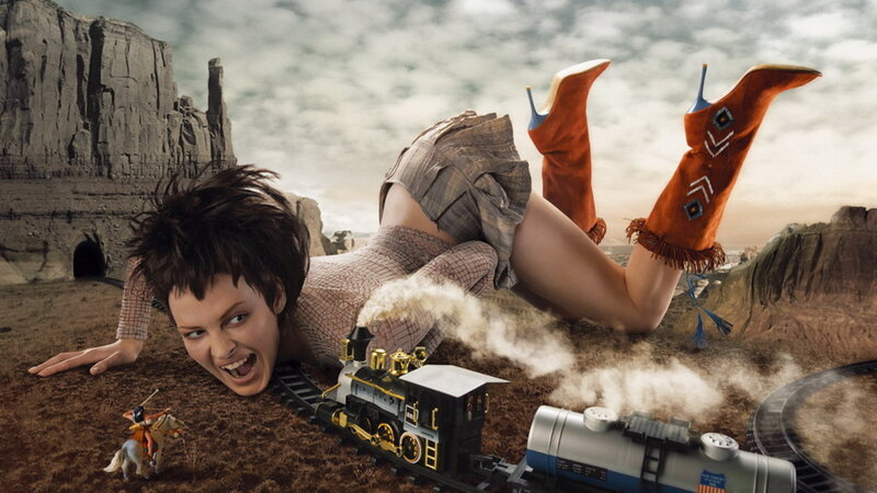 woman with toy train in desert