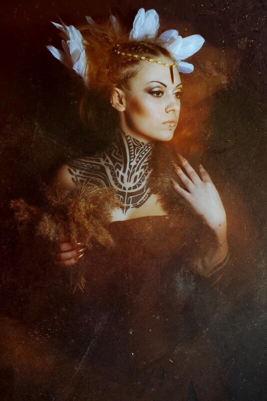 woman with tribal tattoos and feathers