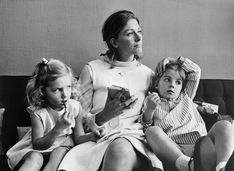 woman with two children on couch