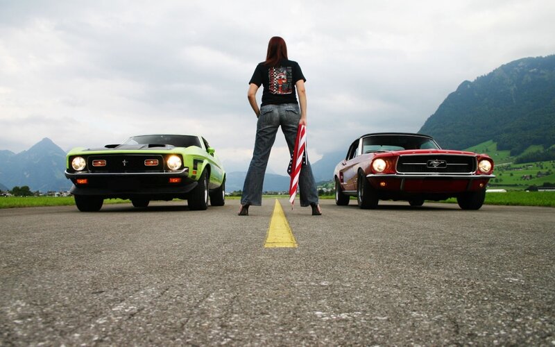 Woman with Two Classic Cars