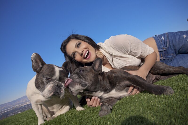 Woman with two French bulldogs