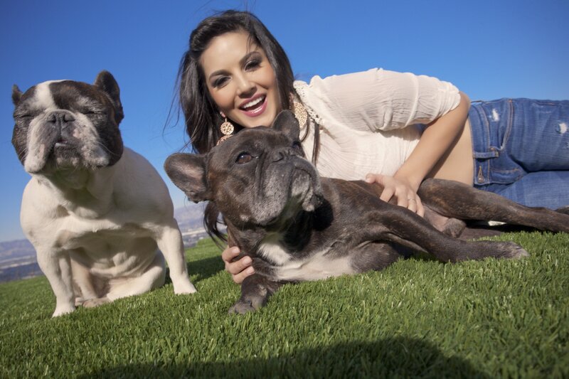 Woman with two French bulldogs