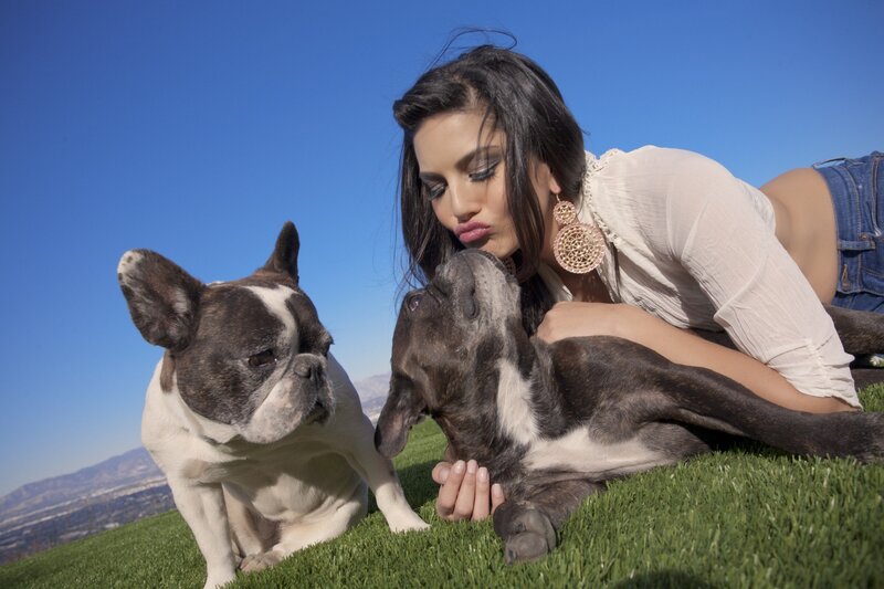 Woman with two French bulldogs