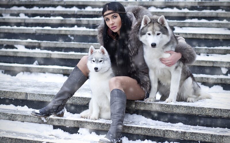 Woman with Two Huskies