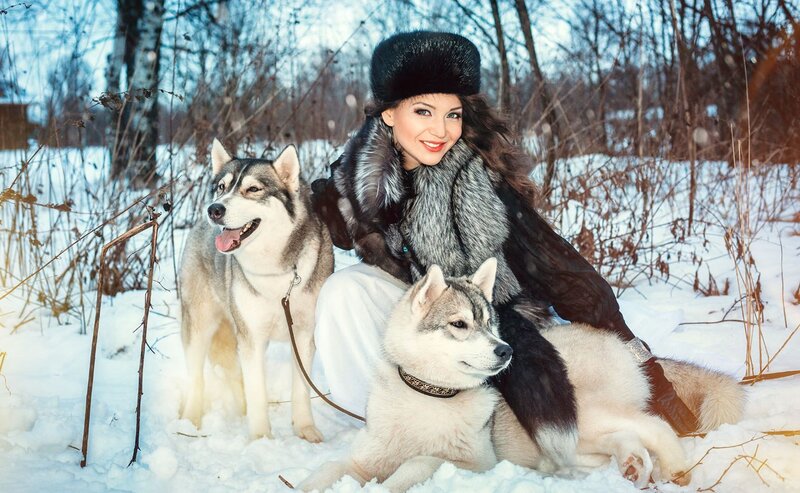 Woman with Two Huskies — White, Serene, Winter