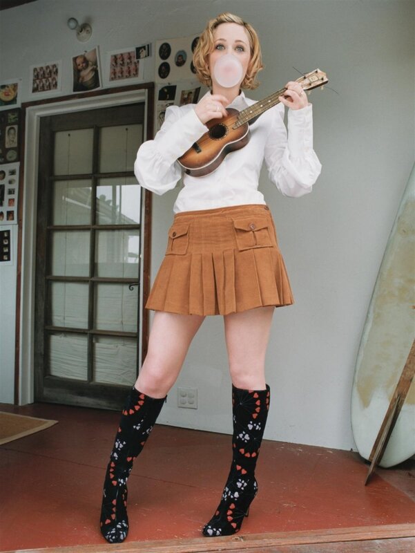 Woman with ukulele and bubble gum
