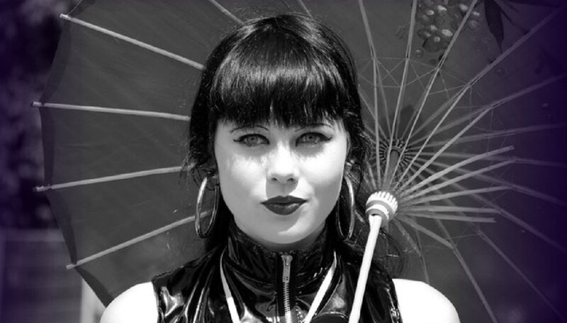 woman with umbrella and bold makeup