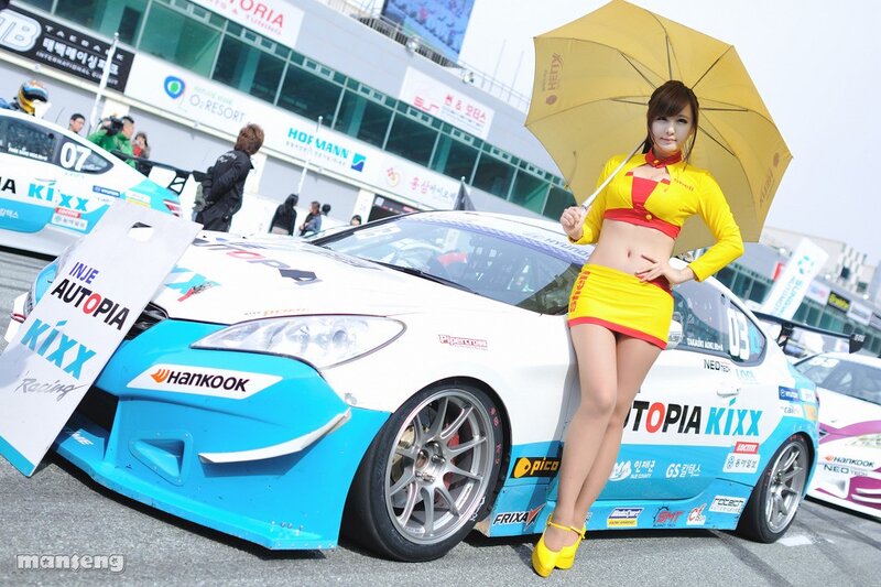 Woman with umbrella at race track