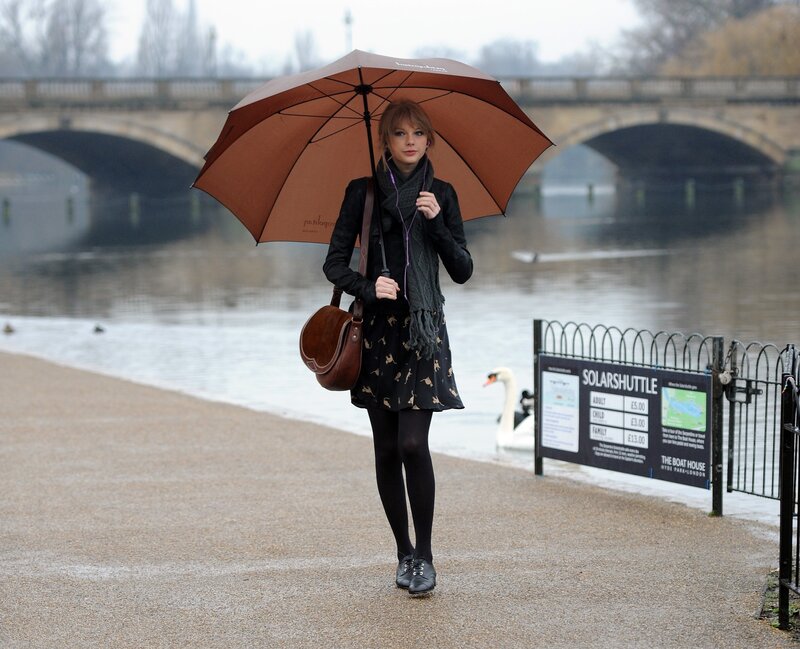 woman with umbrella by river