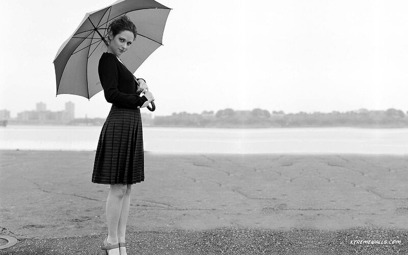 woman with umbrella by water