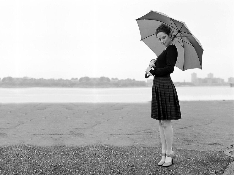woman with umbrella by water