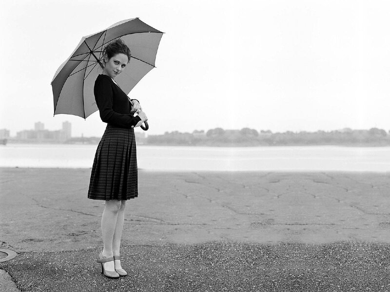 woman with umbrella by water