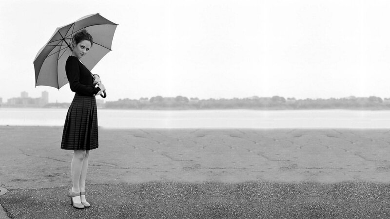 woman with umbrella by water