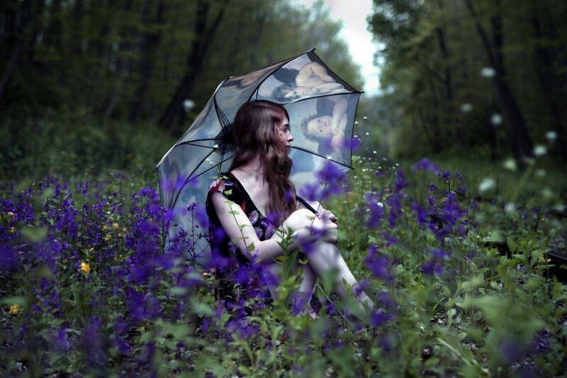 woman with umbrella in field