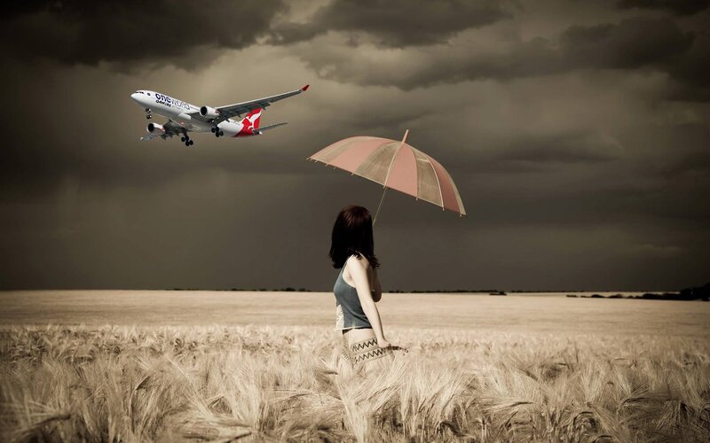 Woman with umbrella in field