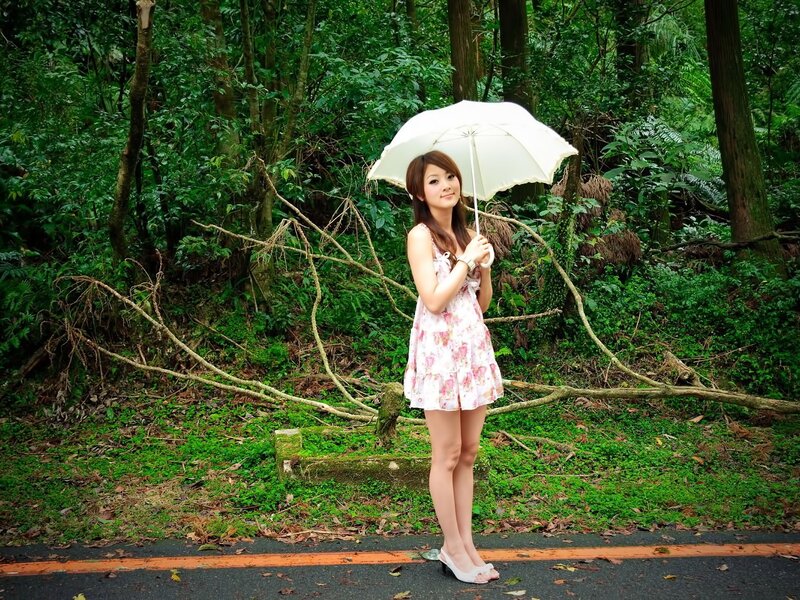 Woman with umbrella in forest
