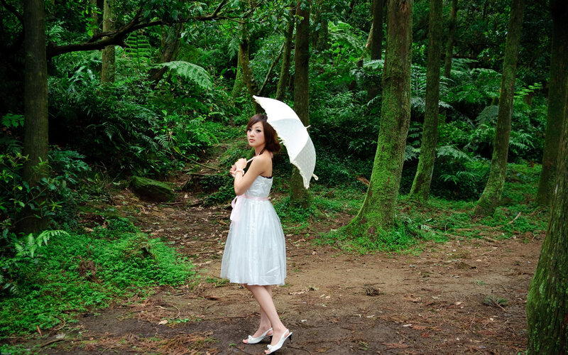 Woman with umbrella in forest