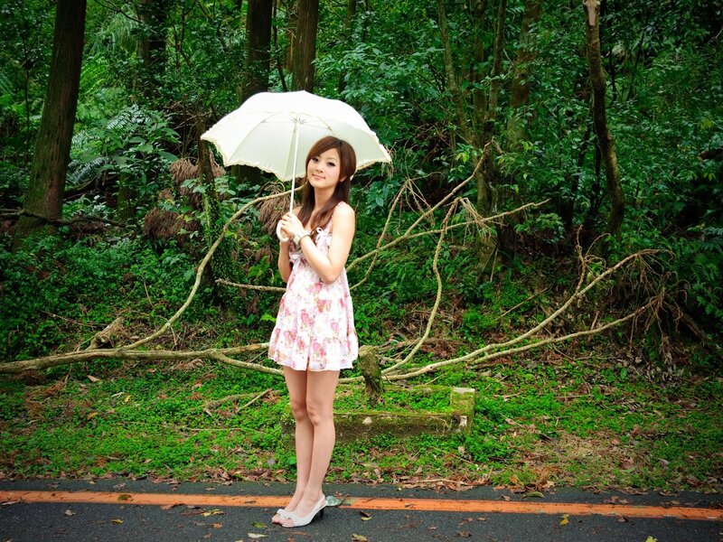 Woman with umbrella in forest