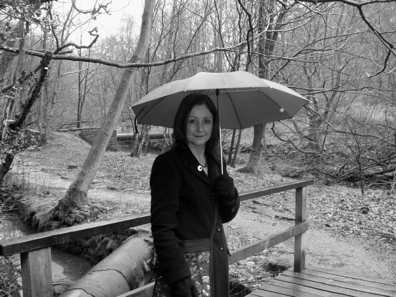 Woman with umbrella in forest