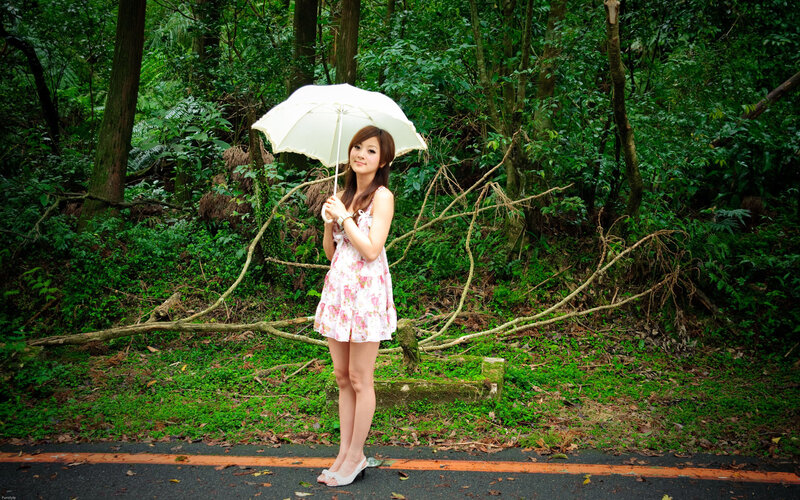 Woman with umbrella in forest