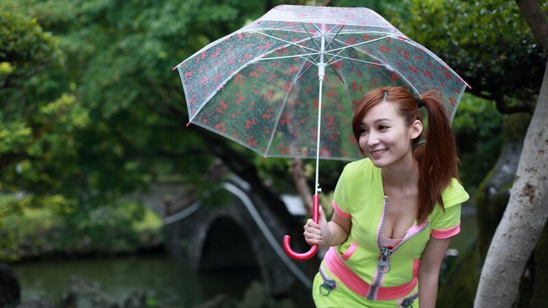 Woman with umbrella in garden