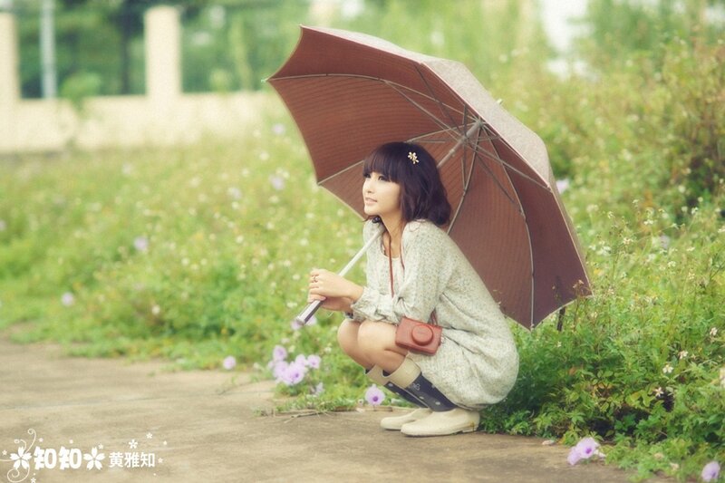Woman with umbrella in garden