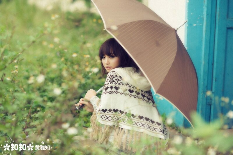 woman with umbrella in garden