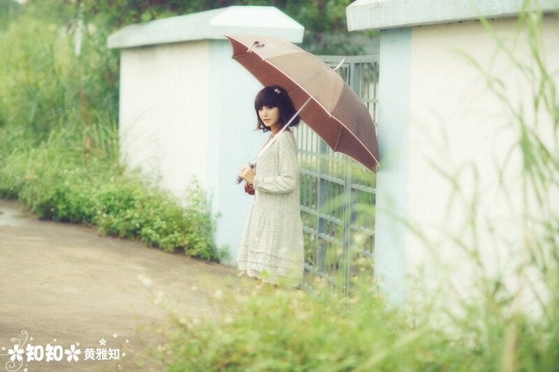 Woman with umbrella in garden