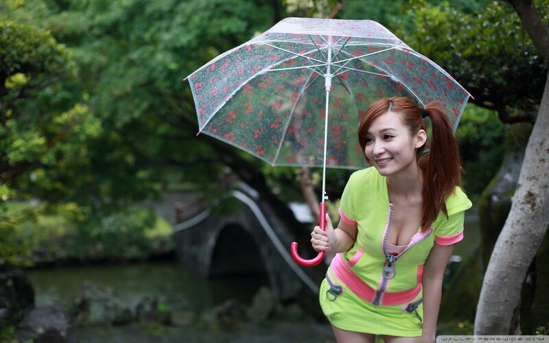 Woman with umbrella in garden