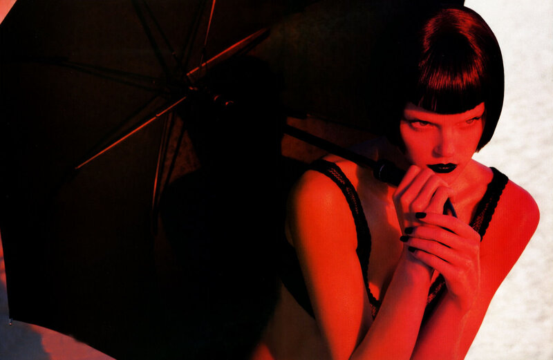 woman with umbrella in red light