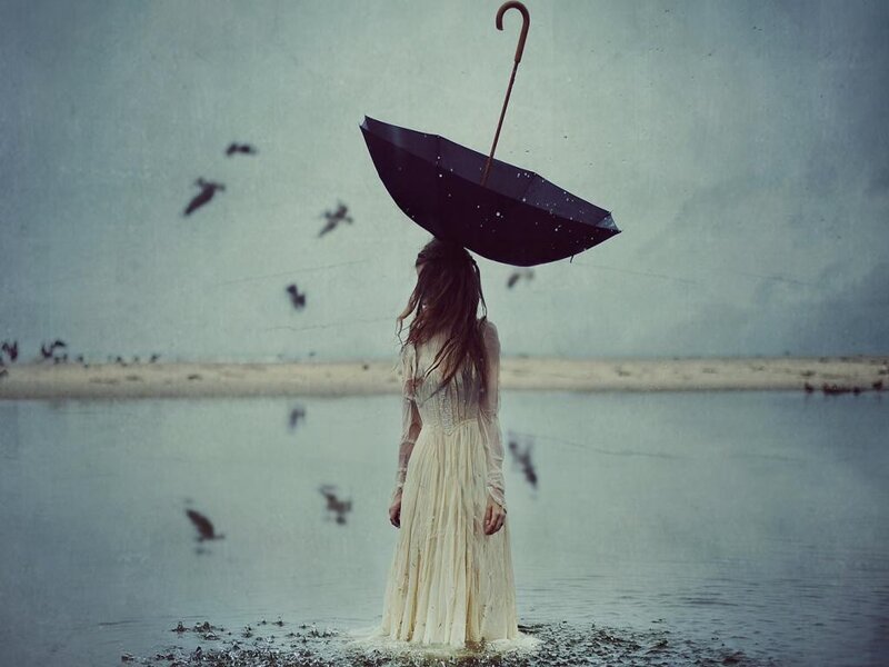 Woman with umbrella in water