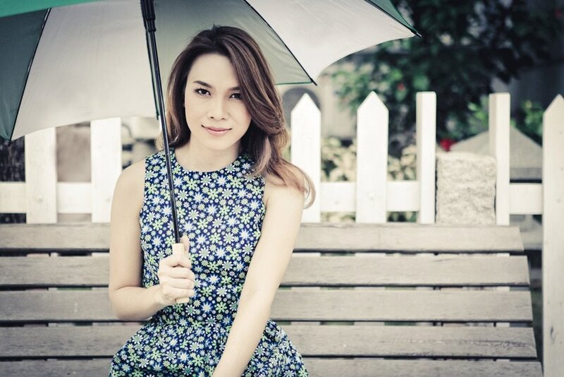 woman with umbrella on bench
