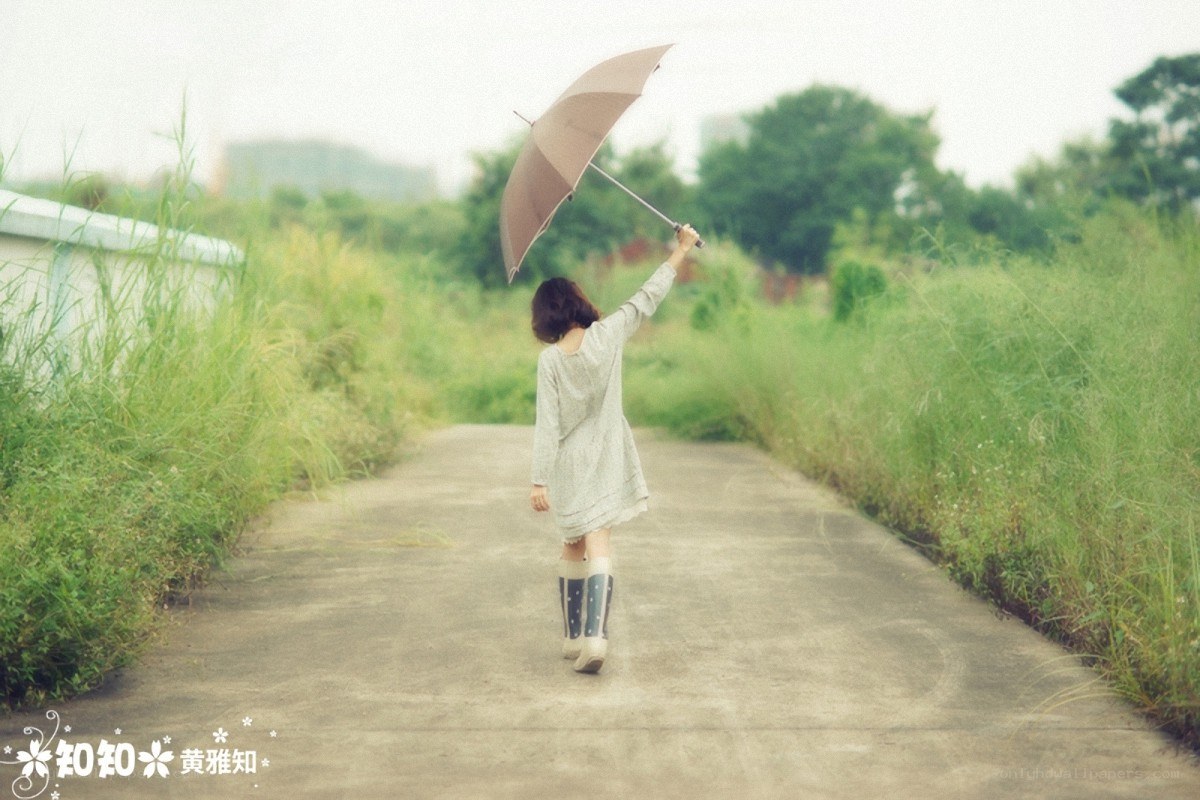 Woman with umbrella on path