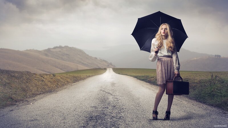 woman with umbrella on road
