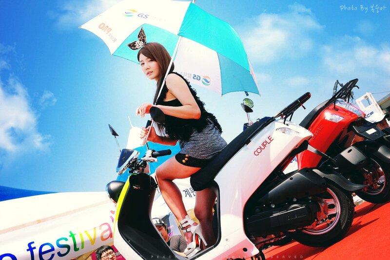 Woman with umbrella on scooter