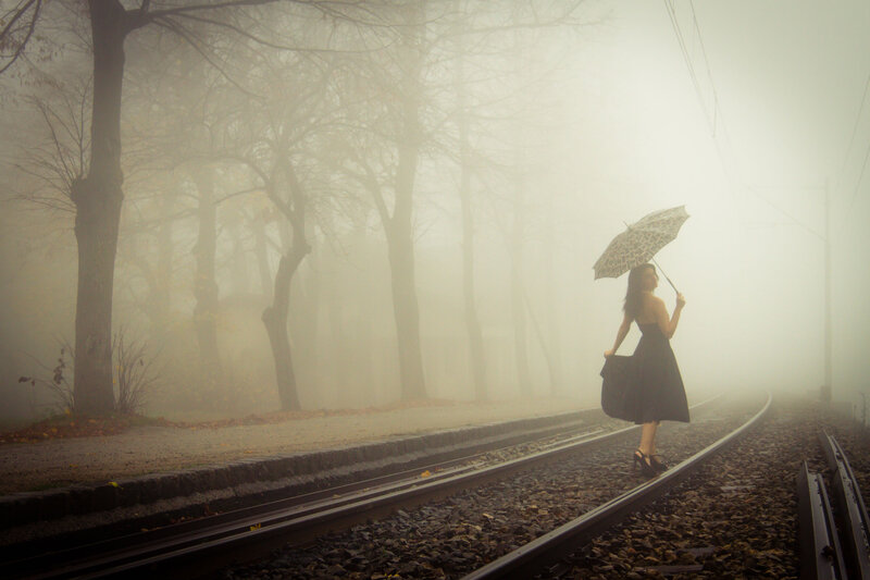 Woman with Umbrella on Tracks
