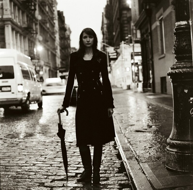 woman with umbrella on wet street