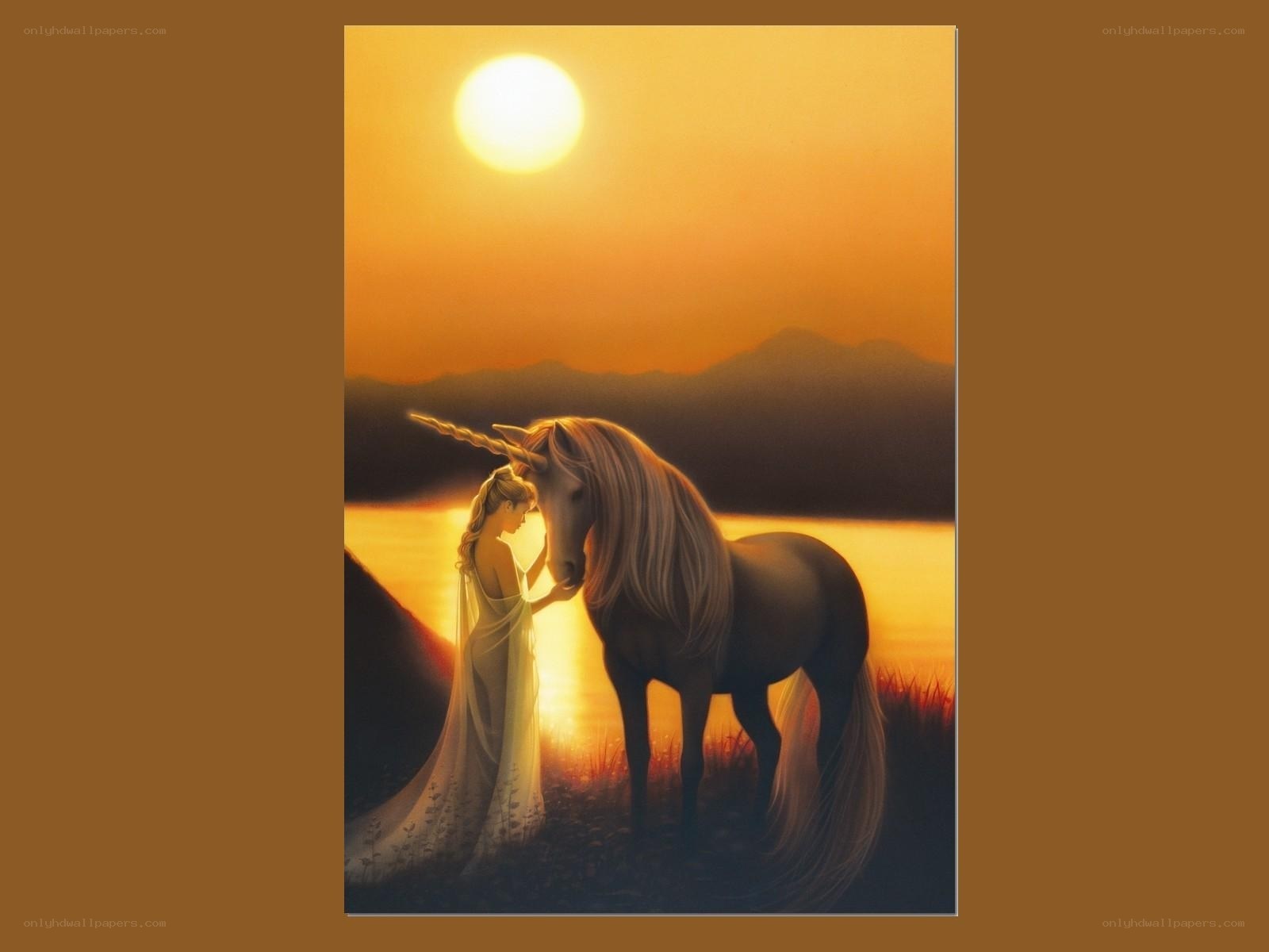 woman with unicorn at sunset