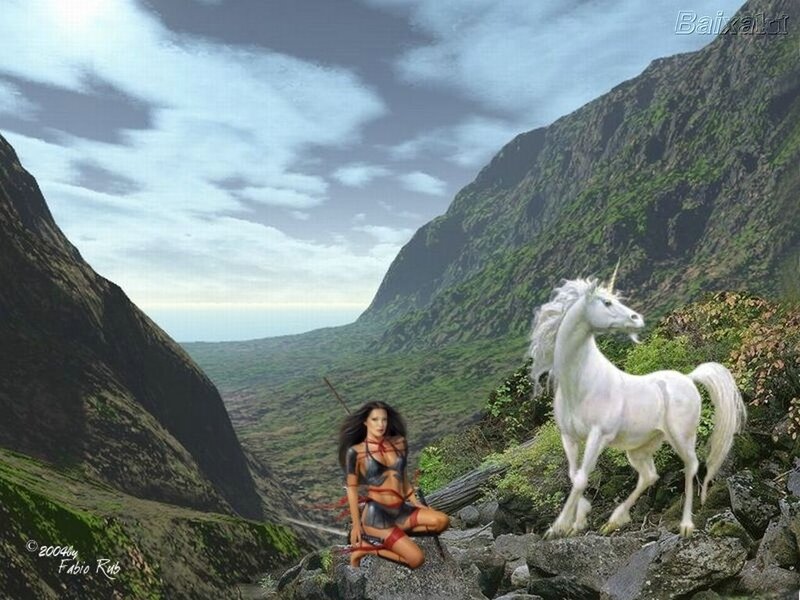 Woman with unicorn in mountain valley
