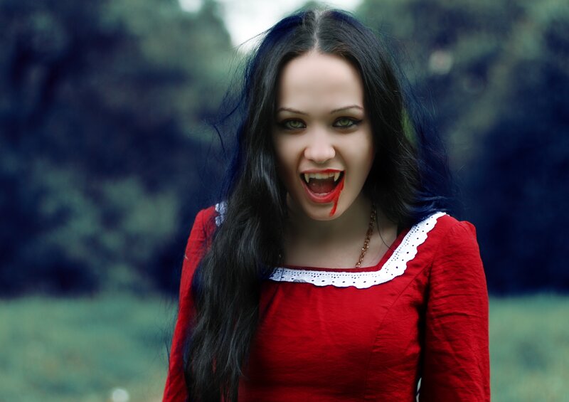 woman with vampire fangs