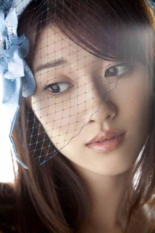 woman with veil and blue bow