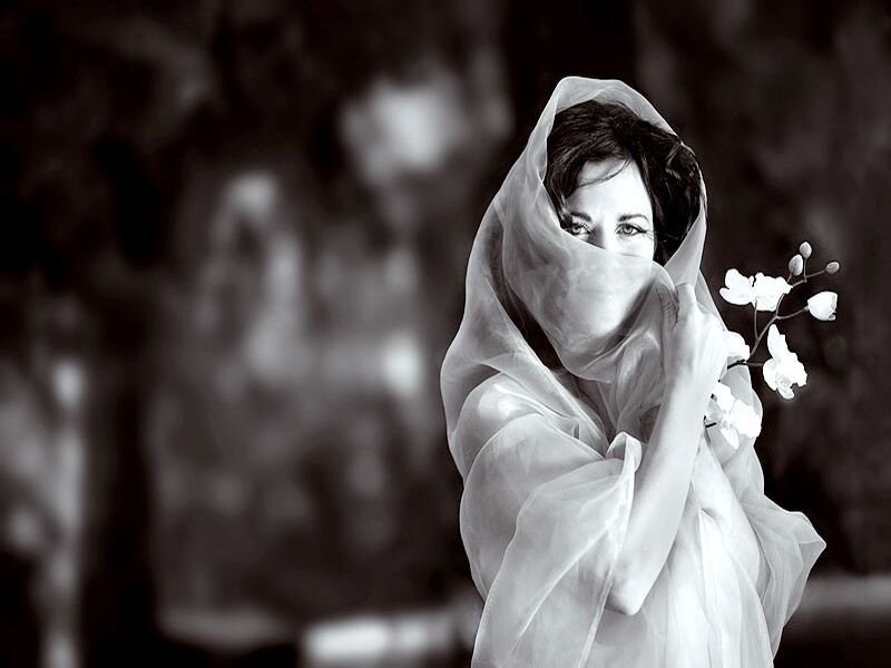 Woman with Veil Holding Flowers